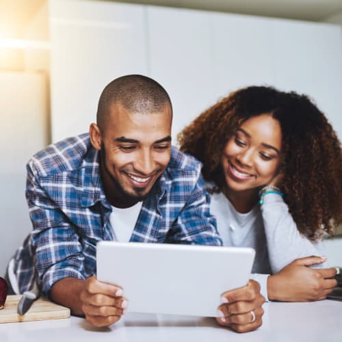 A happy couple watching iPad at Osprey Point in Virginia Beach, Virginia