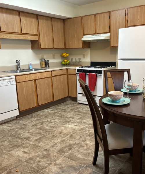Cozy kitchen with wooden cabinetry at MeadowView Townhomes in Goshen, Ohio