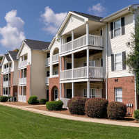 Exterior of an apartment building and grass in front at Ten68 West in Dallas, Georgia