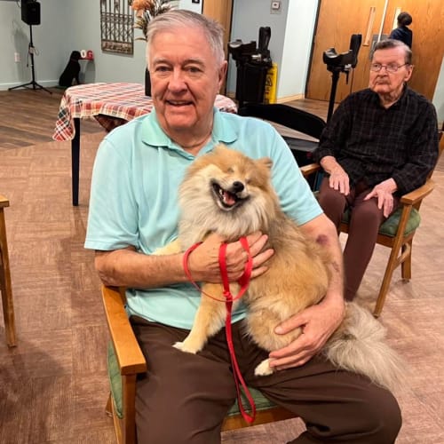 Smiling resident with elvis at Oxford Glen Memory Care at Sachse in Sachse, Texas