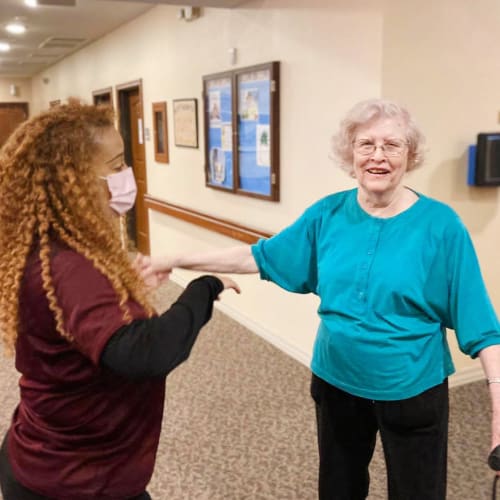 Resident and caretaker dancing of Oxford Glen Memory Care at Carrollton in Carrollton, Texas
