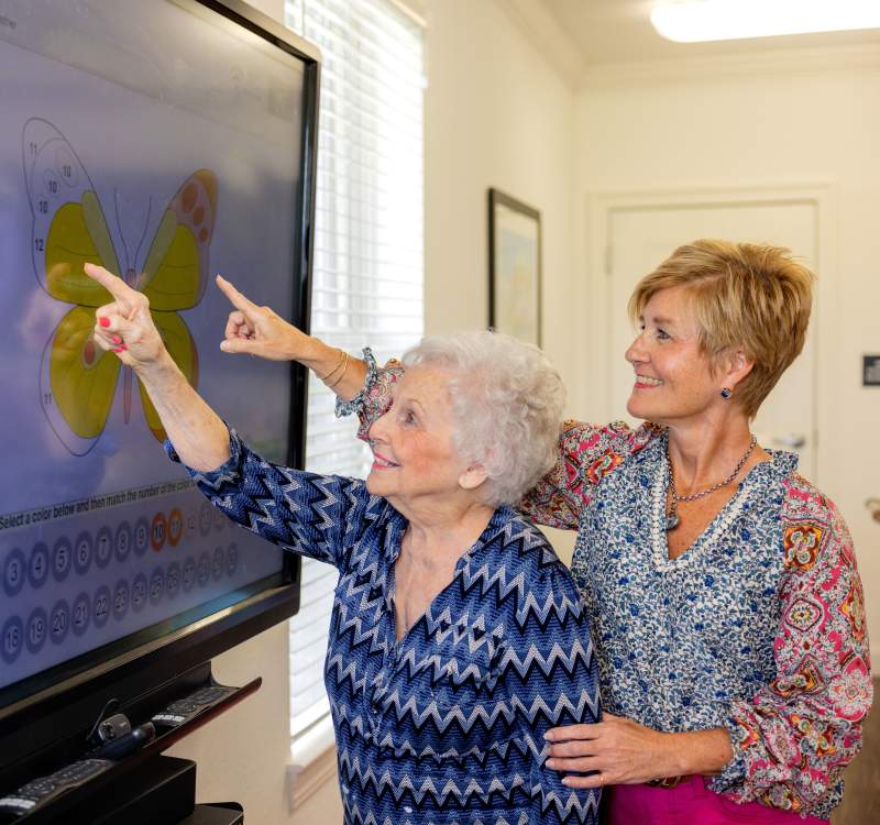 Residents looking at a idea board screen at Glenncrest at Webb Gin in Lawrenceville, Georgia