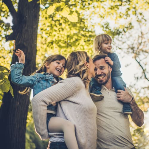 Residents carrying their children in a park near Midway Manor in Virginia Beach, Virginia