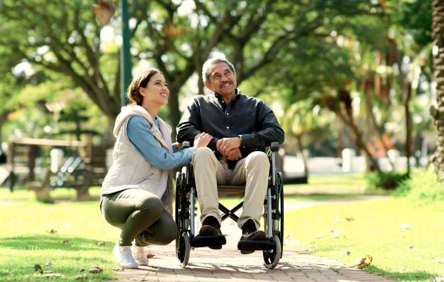Elder resident in the wheel chair along with younger resident near Park Hacienda Apartments in Pleasanton,California