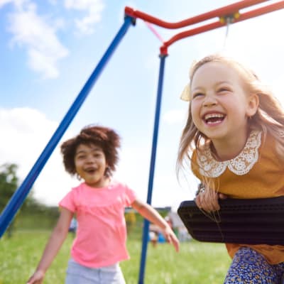 couple of kids playing on a swing set at Meriwether Landing in Joint Base Lewis McChord, Washington