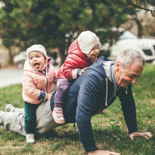 Senior resident in park with kids at Eagle Park Vistas in Hanover, Maryland