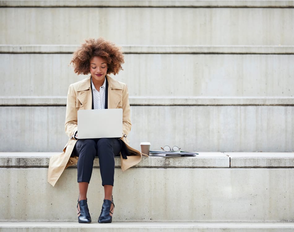 Resident student doing some homework on her laptop near Sofi at Salem Station in Salem, Massachusetts