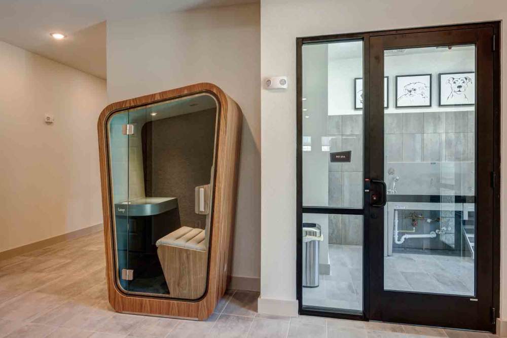 Wooden phone booth sits in a hallway at The Abbey at Veramendi in New Braunfels, Texas