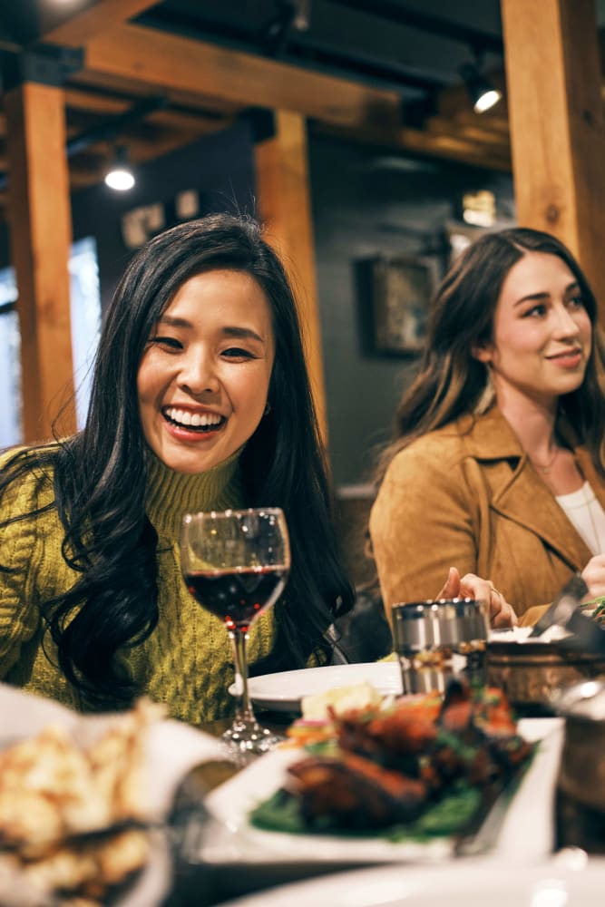 Friends enjoying dinner near 55 Brighton at Packard Crossing in Boston, Massachusetts