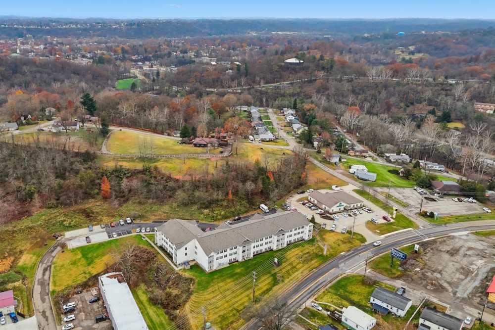 Aerial view of apartment community surrounded by greenery and residential areas at Norwood Greene Senior Living in Marietta, Ohio