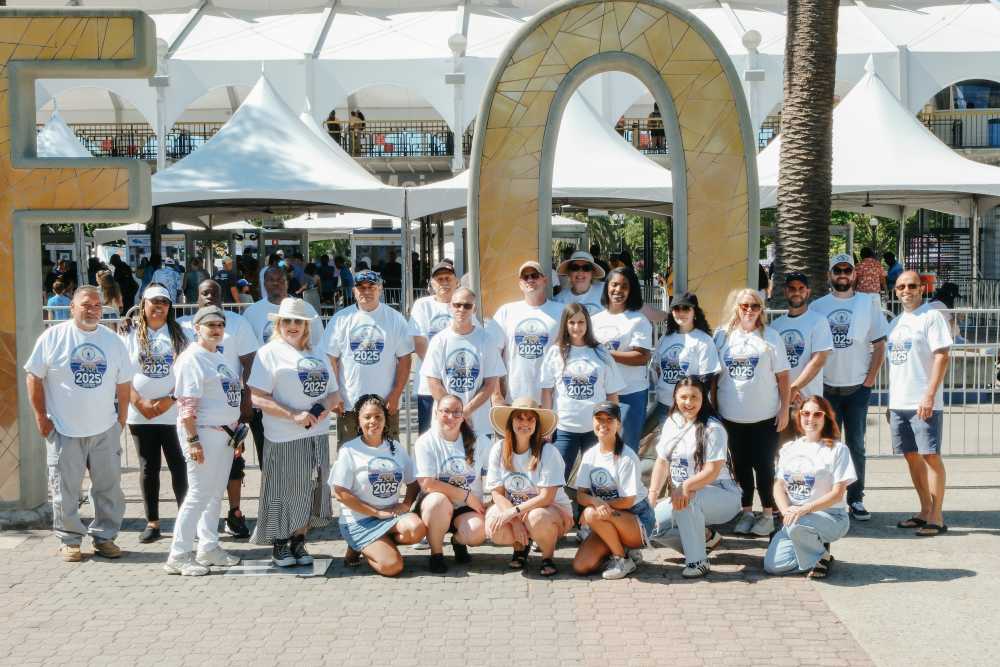 Employees sitting watching an outdoor event near Ray Stone Inc.