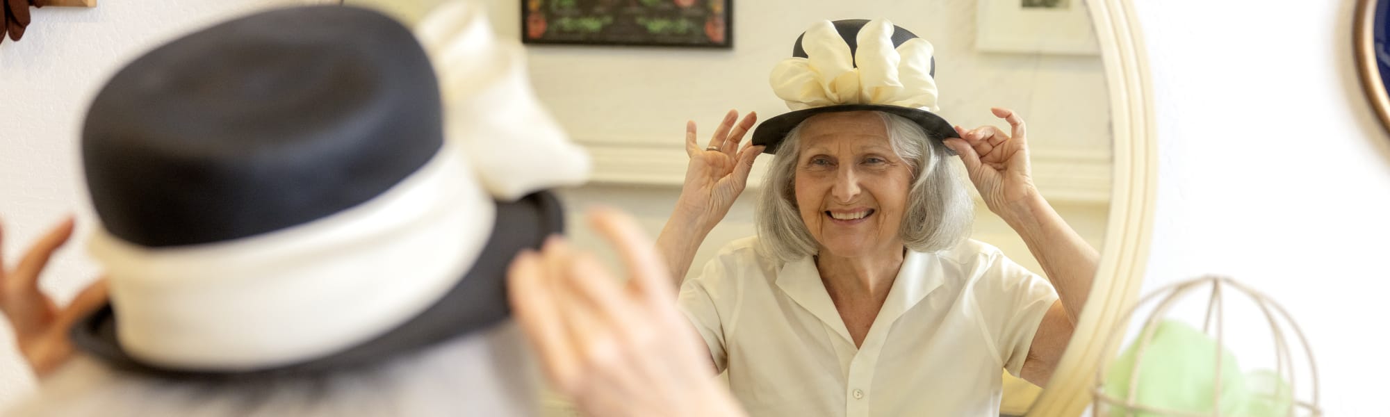 Senior resident looking into the mirror at The Barclay at ParkSquare in Aventura, Florida