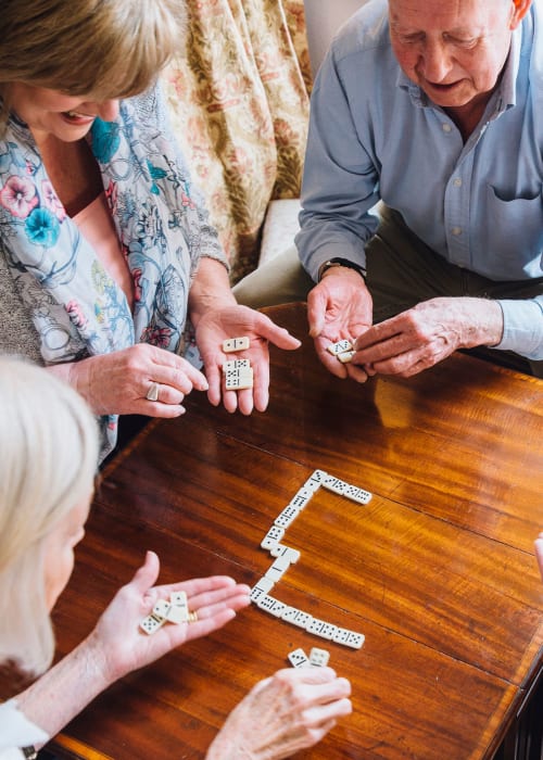 Group of residents playing dominos at English Meadows Lexington Campus in Lexington, South Carolina
