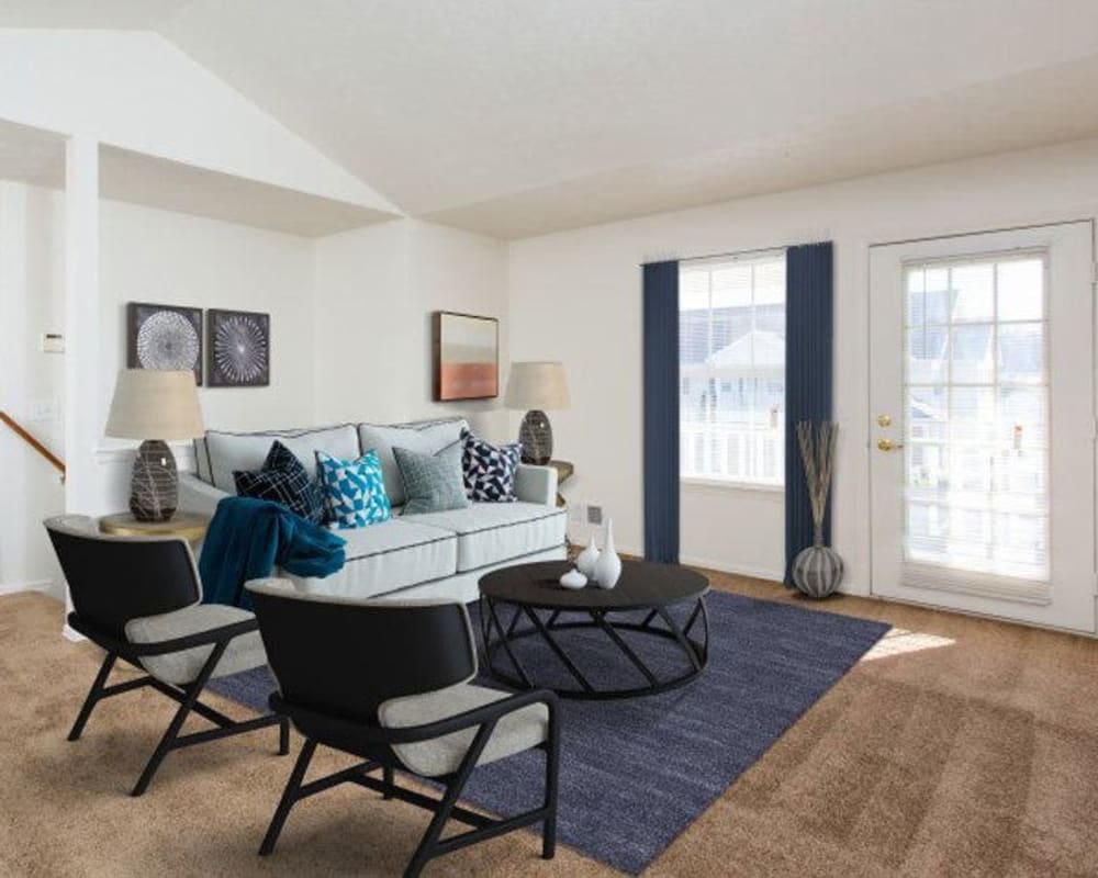 Spacious model living room with plush carpeting at Astoria Park Apartment Homes in Indianapolis, Indiana