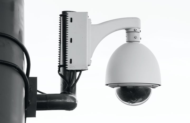close up of a security camera mounted on a pole