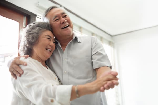 A couple dancing in their apartment at AgeWell Living