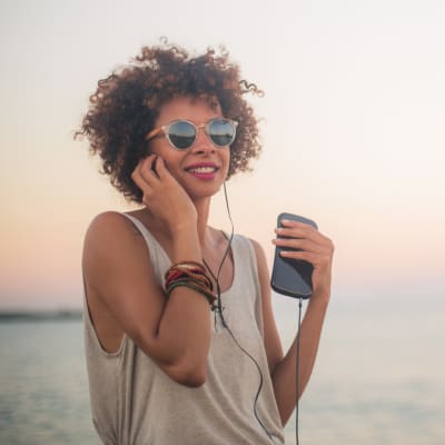 A resident listening to music on the beach at San Mateo Point in San Clemente, California