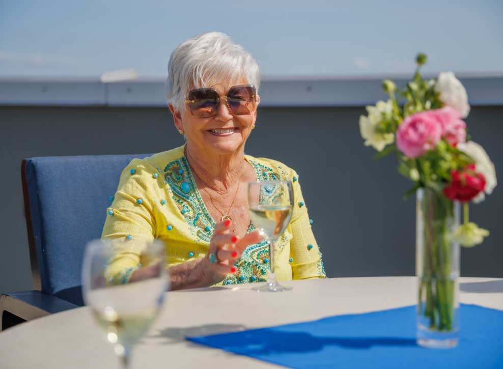 Resident drinking wine on deck at Murano in Seattle, Washington