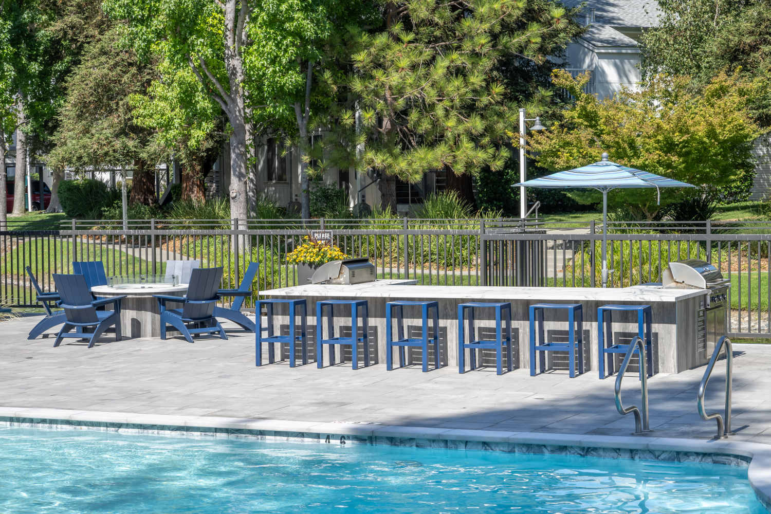 Swimming pool deck seating at Cotton Wood Apartments in Dublin, California
