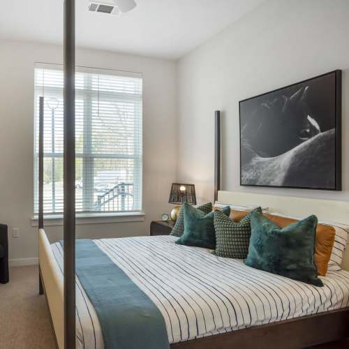 Comfortably furnished bedroom in a model home at The Oliver in Charlotte, North Carolina