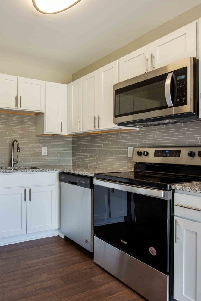 Kitchen with stainless steel appliances and white cabinets at Morningside Apartments & Townhomes in Owings Mills, Maryland