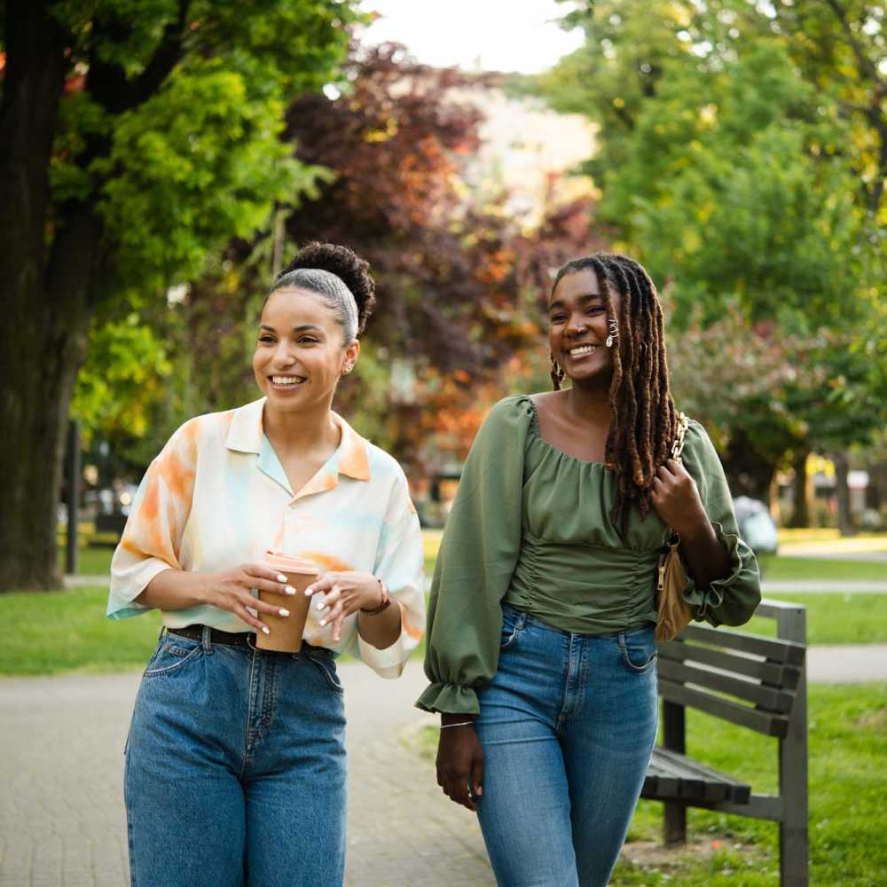 Two women walking together at a park near The Ariel in Charlotte,North Carolina