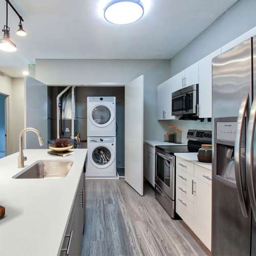 Modern kitchen with stainless steel appliances and an in-home washer and dryer at Buckstone Flats in Lockbourne, Ohio