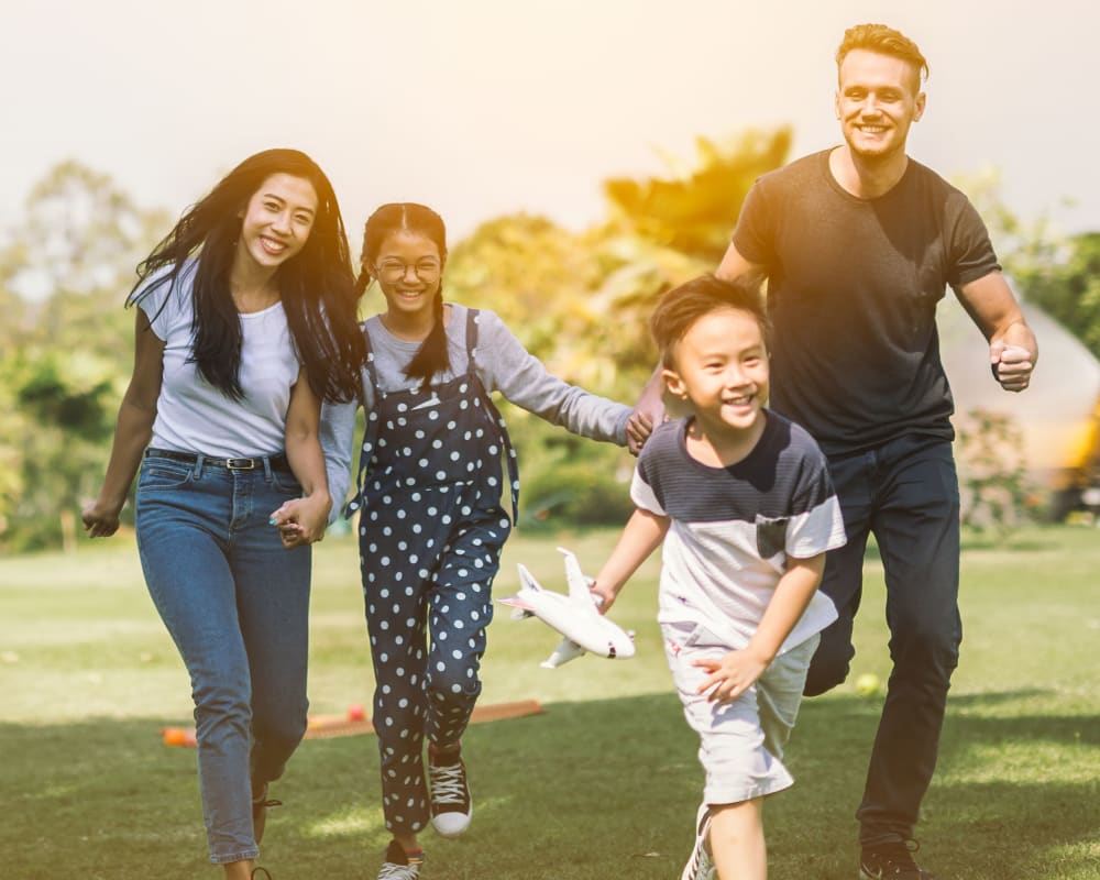 A family playing in a park near The Village at Whitehurst Farm in Norfolk, Virginia