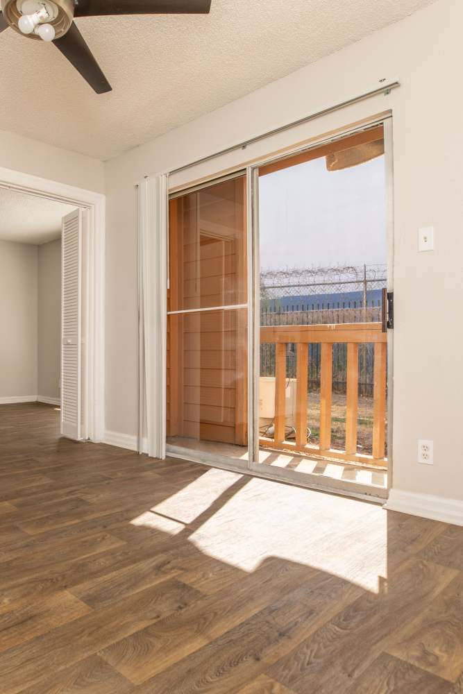 Comfortably furnished primary bedroom in a model apartment at Fredericksburg Place Apartments in San Antonio, Texas