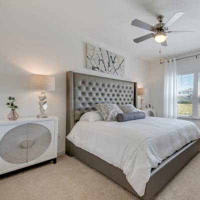 Bright furnished bedroom at Champions Vue Apartments in Davenport, Florida