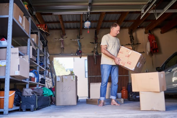 A man packing boxes in his garage near Everest Self Storage - Davie in Davie, Florida