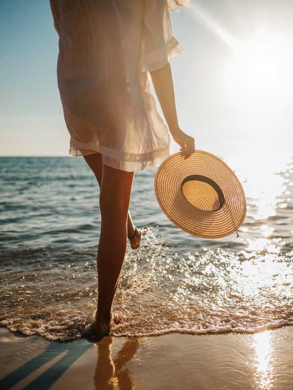 Resident dipping her toes in the water at the beach near Visions at Willow Pond in West Palm Beach, Florida