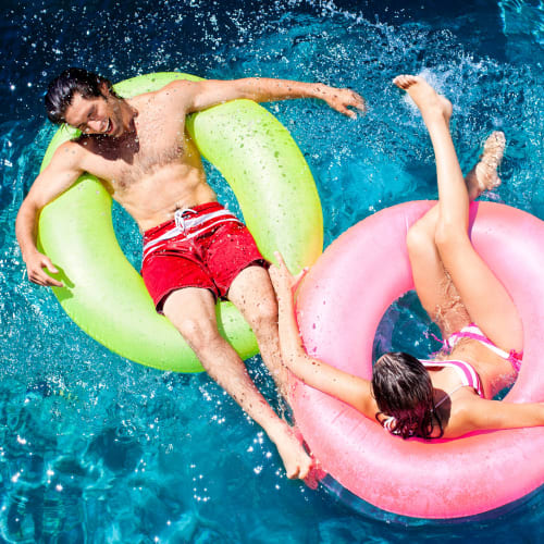 Two residents floating in the pool at Avisa Lakes in Orlando, Florida