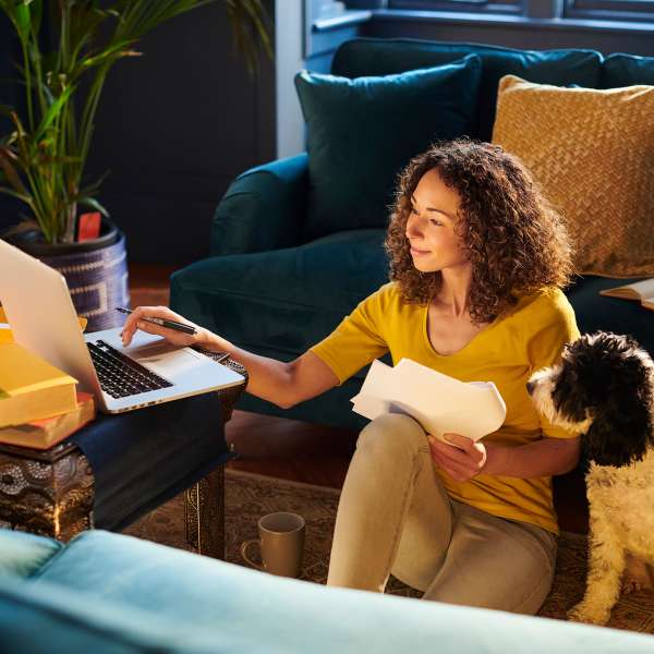 A resident works from home with her dog at Attain at Towne Centre, Fredericksburg, Virginia