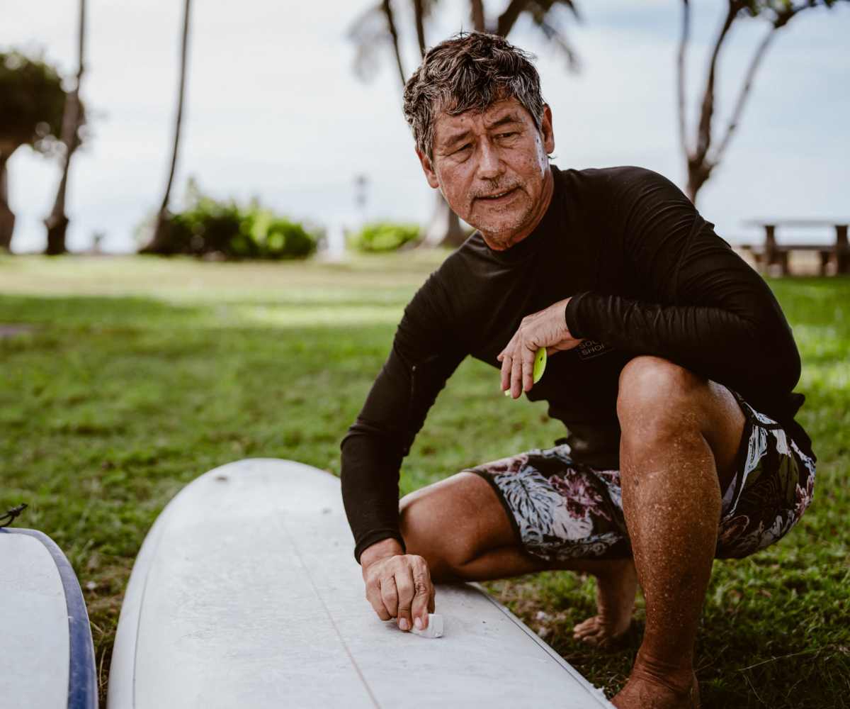 A senior resident with his surfboard at Hale O Piikea II in Kihei, Hawaii 