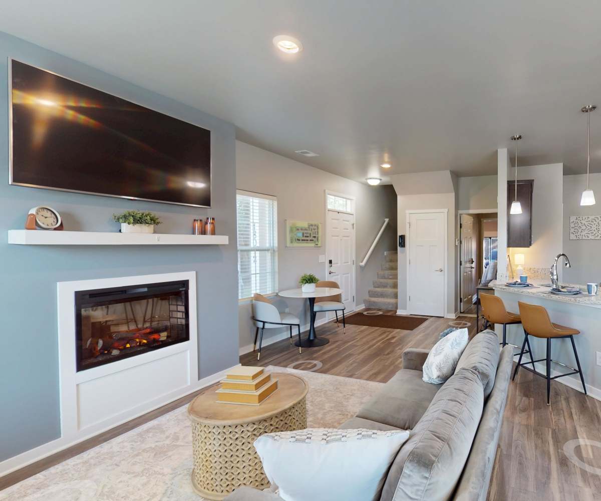 Living room with laminate wood flooring and view to kitchen at Spring Haven in Southfield, Michigan