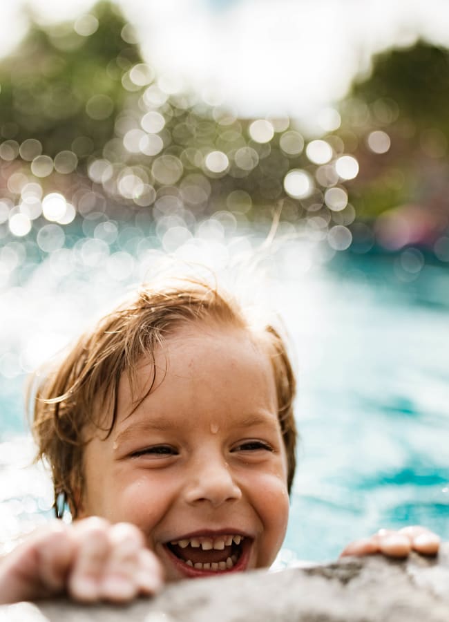 Resident child having a blast in the pool at Pentagon Apartment Homes in Fremont, California