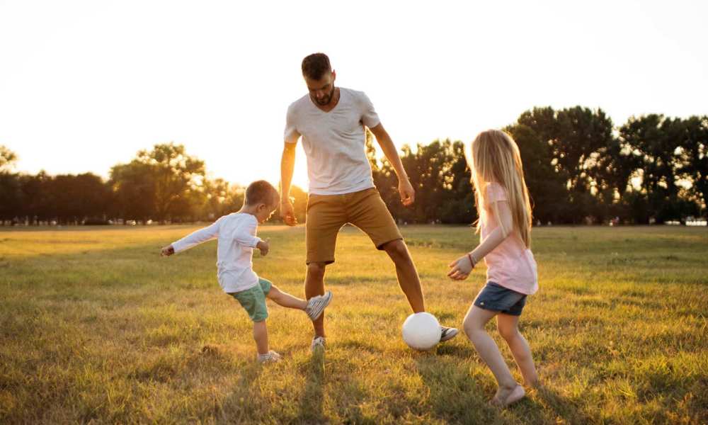 Resident with his kids playing at a park near Artspace Lofts Mount Rainier in Mount Rainier, Maryland
