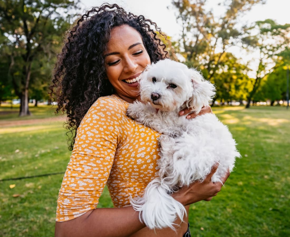 A resident holding her small dog at Forest Edge Townhomes in Raleigh, North Carolina