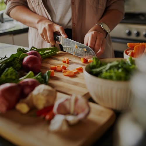 A resident preparing a meal in a home at Madigan in Joint Base Lewis McChord, Washington