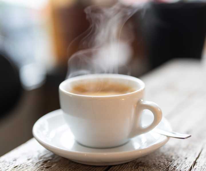 Steaming coffee cup on wooden table at Skyview Downtown in Springfield, Massachusetts 