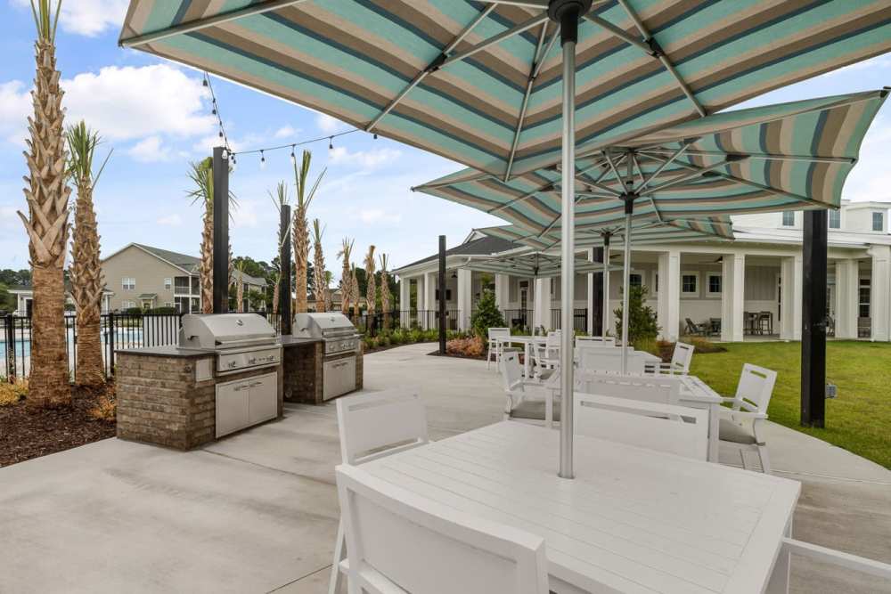 Community park with lots of grass, tables and barbecues at  Hudson Carolina Forest in Myrtle Beach, South Carolina