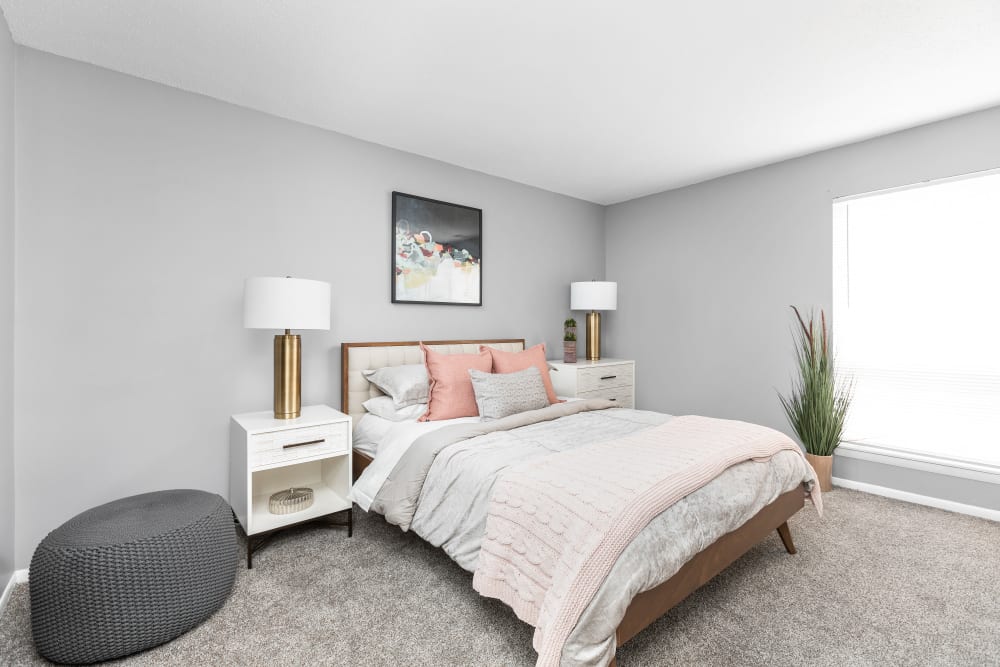 Staged bedroom with wall to wall carpeting