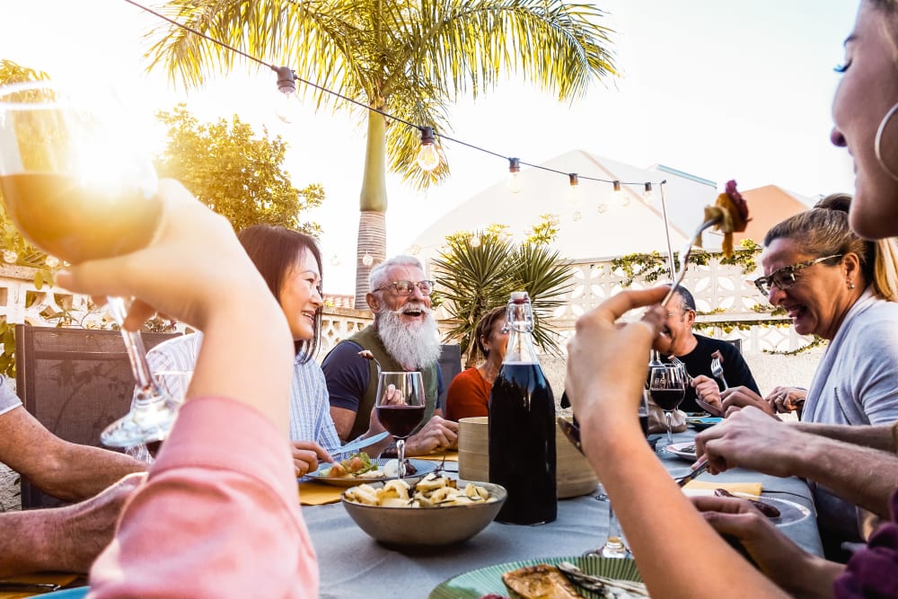 A group of residents holding drinks at Artisan Living Bella Citta in Davenport, Florida