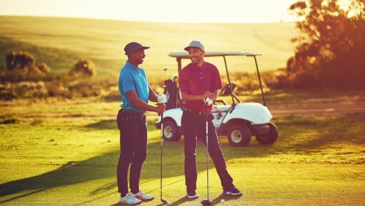 Two men playing golf