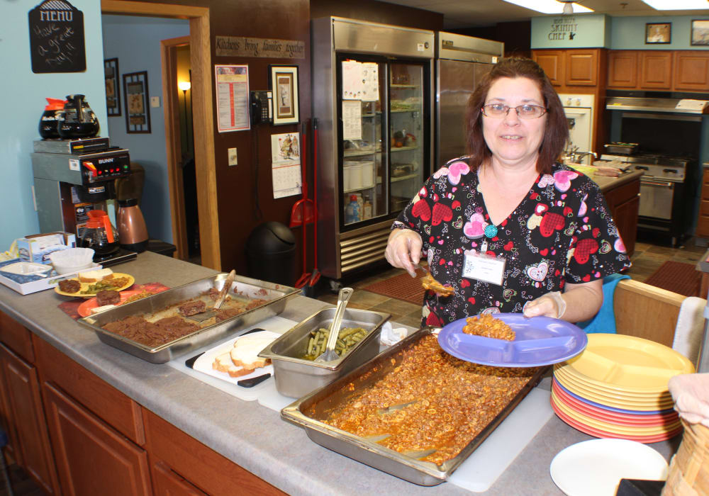 Staff member preparing food in the kitchen at Wellington Meadows in Fort Atkinson, Wisconsin
