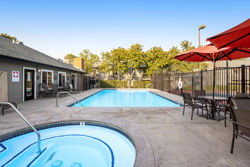 Sundeck with a umbrellas for shade at Sandpiper Village Apartment Homes in Vacaville, California