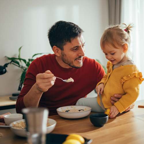 Father and child smiling at each other at Tryon Farms in Charlotte, North Carolina