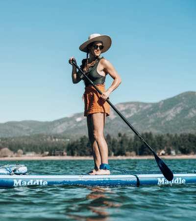 Resident women surfing boat in lake near Haven + Arrow, Rancho Cucamonga, California 