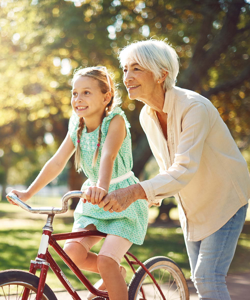 Senior with granddaughter on bike at The Creekside in Woodinville, Washington